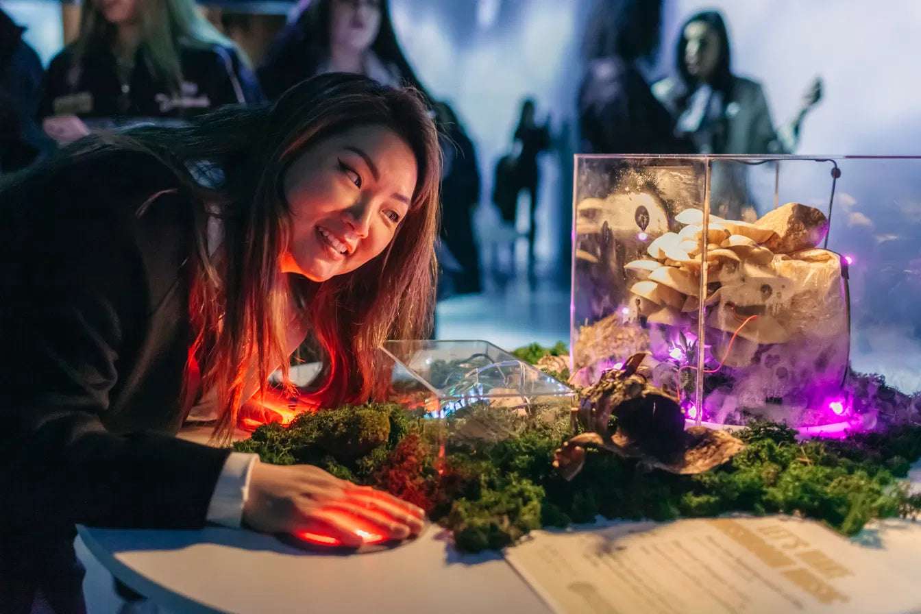 A visitor placing their hand on a station touchpad