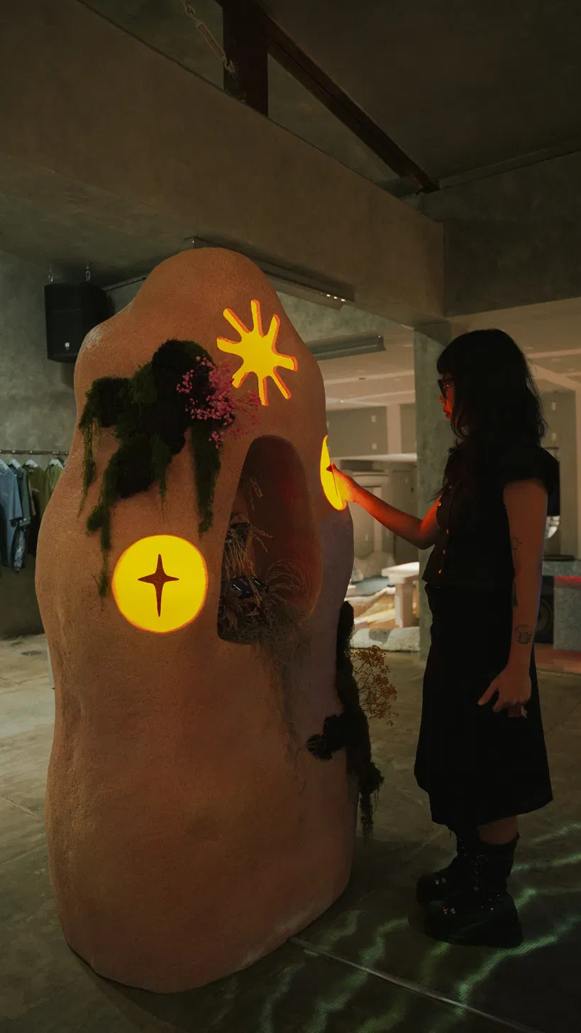 A visitor touching one of the glowing sculptures